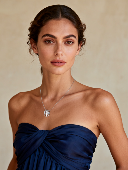 Model wearing Ploutos Jewellery Tree of Life Necklace — elegant 925 sterling silver pendant with colourful zircon stones, symbolising growth, strength, and harmony. A timeless piece from the Abundance Collection, styled with a navy strapless dress for a refined and graceful look.
