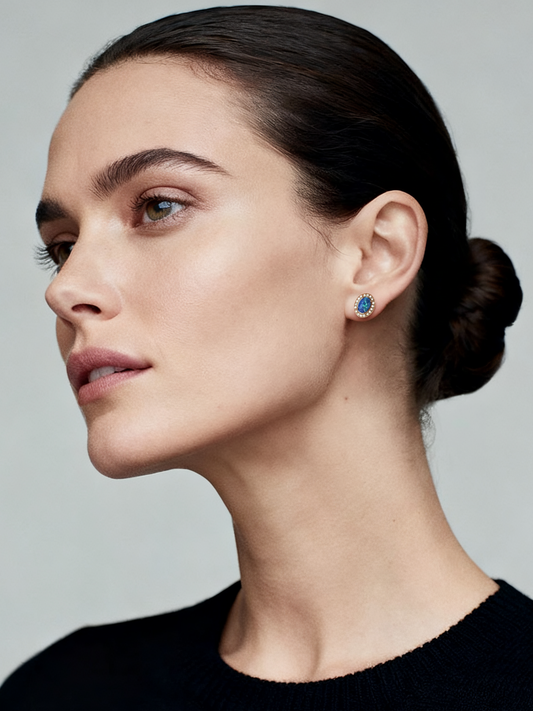 Model wearing Aurora Opal Stud Earrings from Ploutos Jewellery’s Cosmic Energy Collection — rose gold plated 925 sterling silver with vivid blue opal and sparkling halo stones, radiating celestial elegance and timeless beauty.