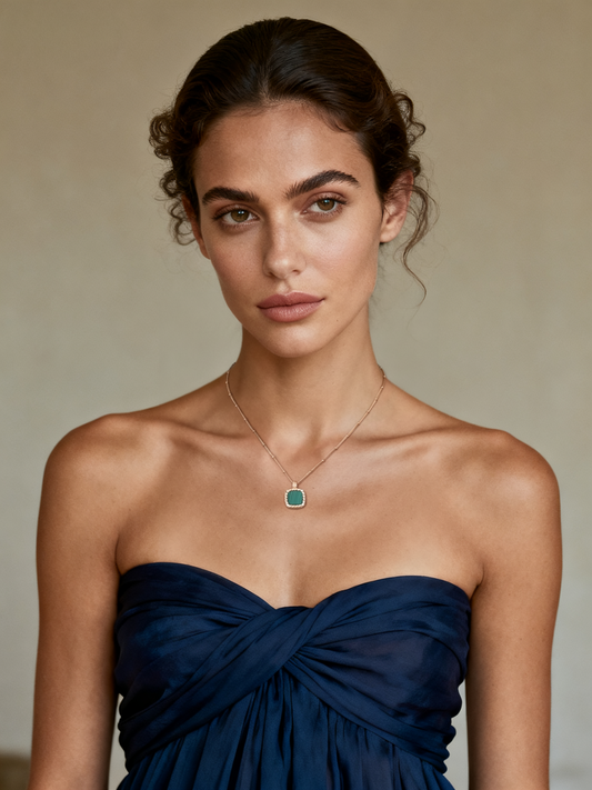 Model wearing Ploutos Jewellery Emerald Crest Malachite Gold Necklace — elegant 18K gold-plated 925 sterling silver pendant with a vivid green malachite gemstone. A refined piece from the Cosmic Energy Collection, symbolizing renewal, protection, and inner harmony.