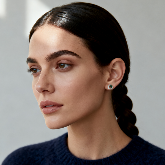 Model wearing Emerald Orbit Stud Earrings in 925 sterling silver from Ploutos Jewellery’s Abundance Collection — featuring a deep green zircon center encircled by white stones, radiating modern elegance and refined confidence.