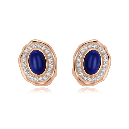 Ploutos Jewellery Midnight Elegance Lapis Stud Earrings — deep blue lapis lazuli center stones surrounded by shimmering crystal halos, handcrafted in 18K vintage gold-plated 925 sterling silver. Inspired by starlit skies, symbolizing calm confidence and timeless beauty from the Cosmic Energy Collection.
