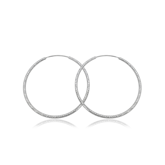 Ploutos Jewellery Eterna 50mm Twisted Silver Hoop Earrings — handcrafted 925 sterling silver hoops with elegant twisted texture, lightweight large silver earrings from the Abundance Collection symbolising modern sophistication and timeless confidence.