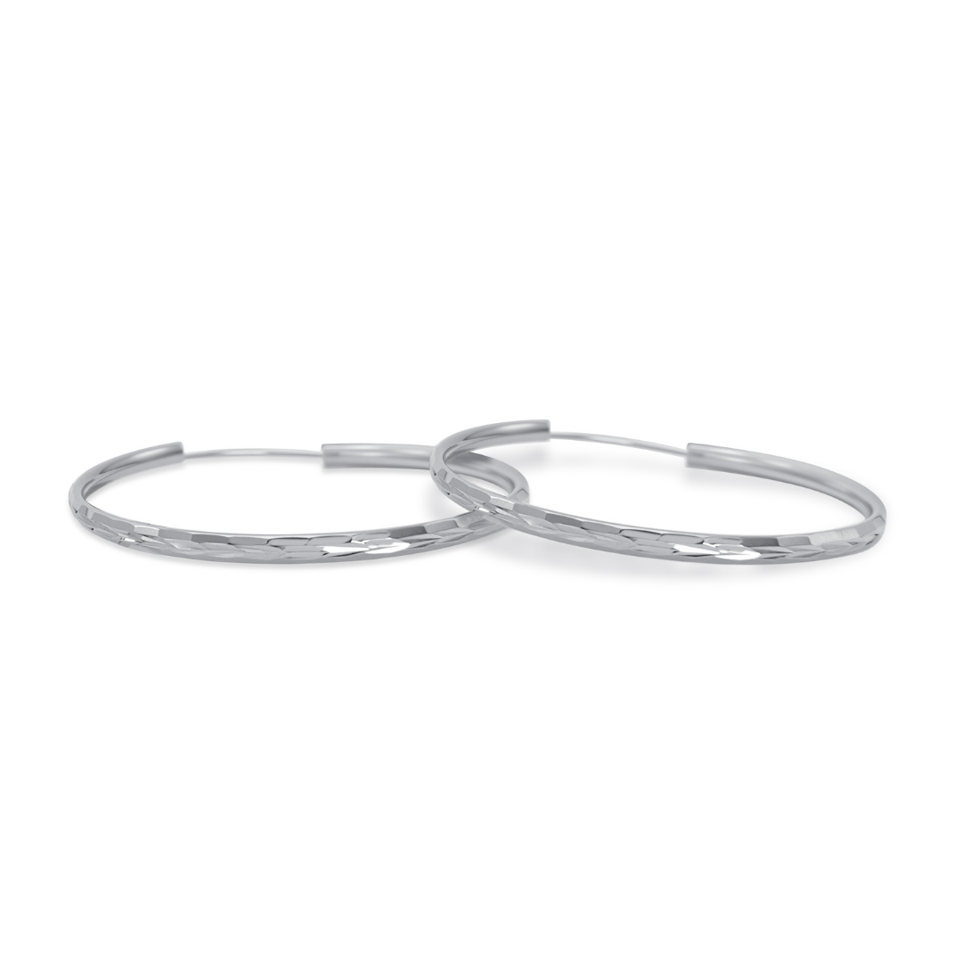 Ploutos Jewellery Luna 50mm Faceted Silver Hoop Earrings — handcrafted 925 sterling silver hoops with mirror-polished faceted texture, elegant minimalist design from the Abundance Collection symbolising refined modern beauty and timeless sophistication.d