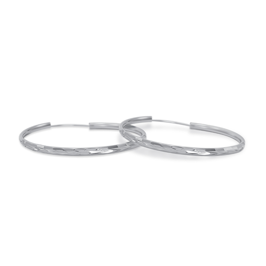 Ploutos Jewellery Luna 50mm Faceted Silver Hoop Earrings — handcrafted 925 sterling silver hoops with mirror-polished faceted texture, elegant minimalist design from the Abundance Collection symbolising refined modern beauty and timeless sophistication.d