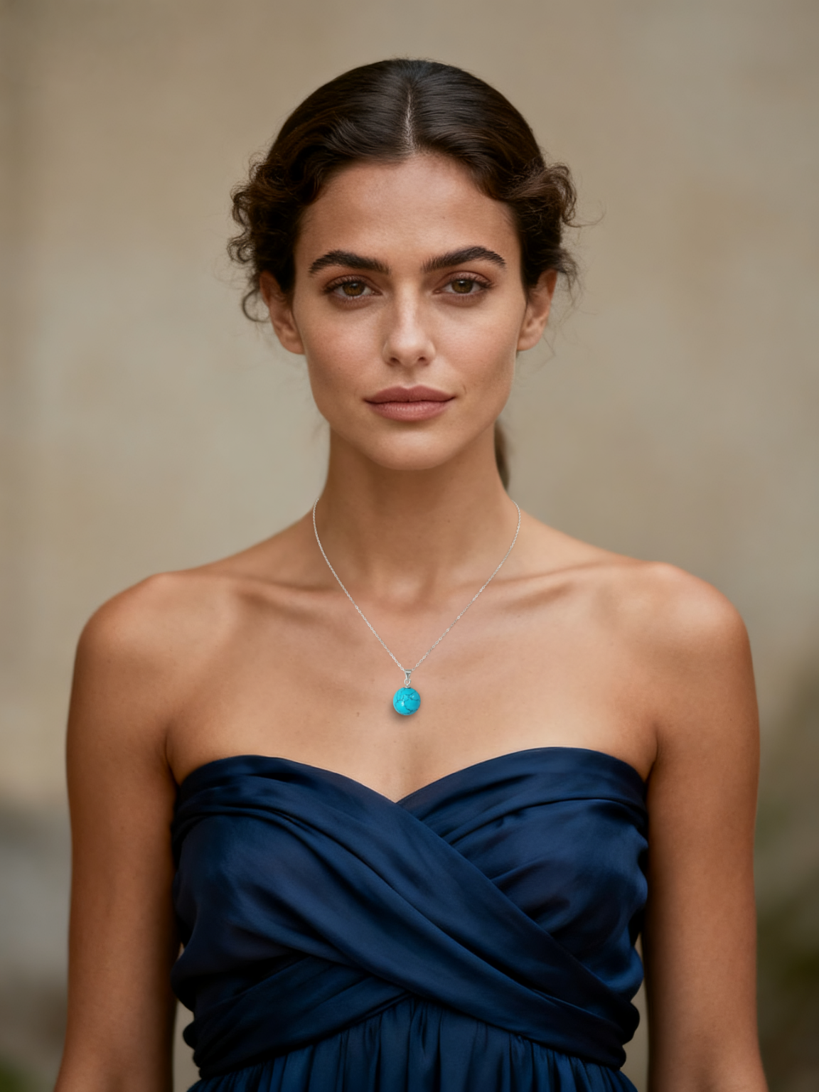 Model wearing Ploutos Jewellery Ocean Spirit Necklace — a minimalist 925 sterling silver chain with a natural turquoise bead pendant from the Cosmic Energy Collection. Styled with an elegant navy strapless dress, this piece embodies serenity, balance, and timeless sophistication.