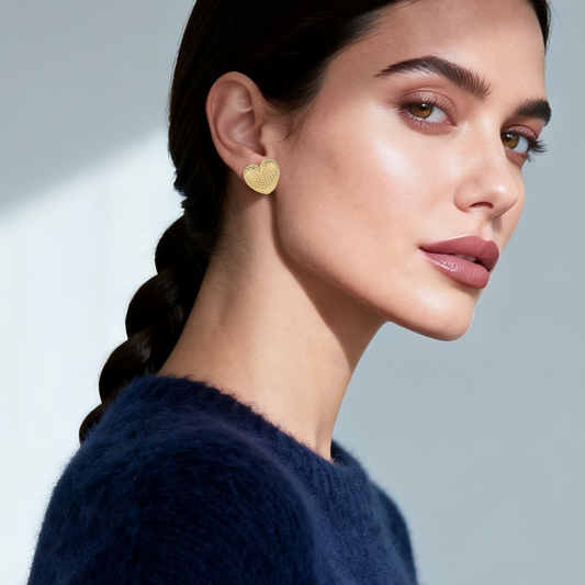 Model wearing 14k gold-plated textured heart stud earrings — elegant statement jewellery from the Wealth Collection by Ploutos Jewellery, embodying love, confidence, and quiet luxury style.