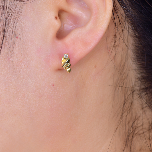 Woman wearing 14K gold-plated textured stud earrings with cubic zirconia crystal from the Abundance Collection — elegant fine jewellery by Ploutos Jewellery, symbolizing prosperity and graceful confidence.