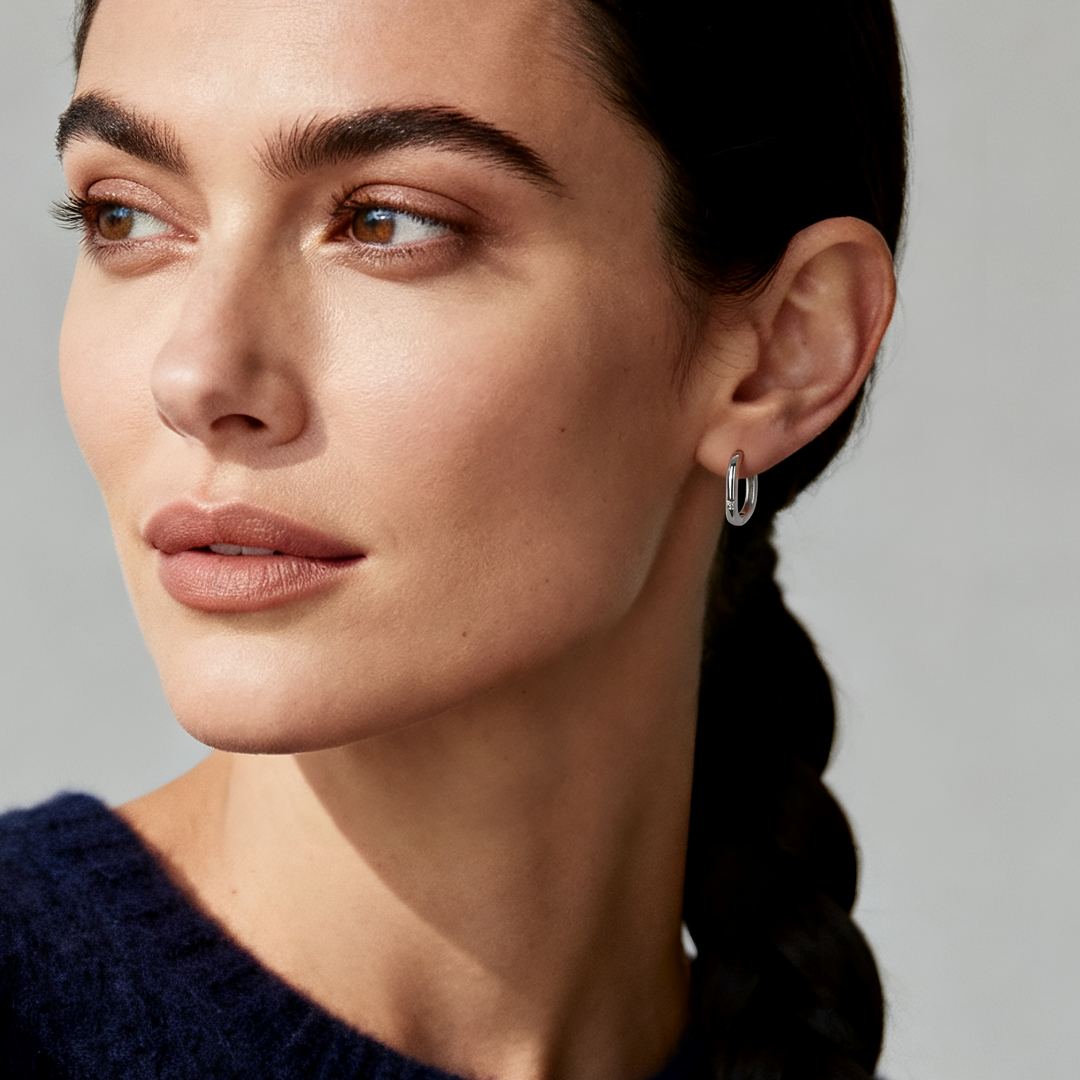Model wearing Ploutos Jewellery Arco Silver Rectangular Hoop Earrings — 925 sterling silver geometric hoops with minimalist modern design, part of the Abundance Collection symbolising quiet strength and refined elegance.