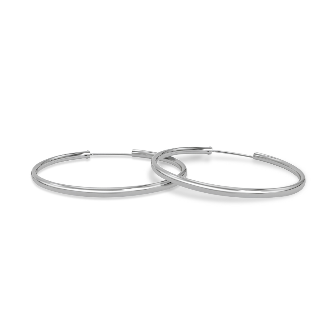 Ploutos Jewellery Astra 50mm Classic Smooth Silver Hoop Earrings — handcrafted 925 sterling silver large hoops with mirror-polished finish, minimalist design from the Abundance Collection symbolising timeless elegance and quiet confidence.