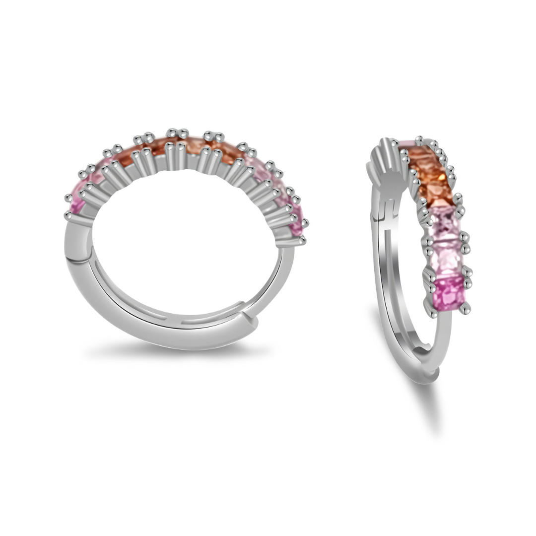 Close-up of Ploutos Jewellery Aurora Gradient Zircon Huggie Hoops — rhodium-plated recycled 925 sterling silver earrings with pink, peach, and champagne gradient zircon stones. From the Abundance Collection, these petite hoops embody radiant elegance and everyday luxury.