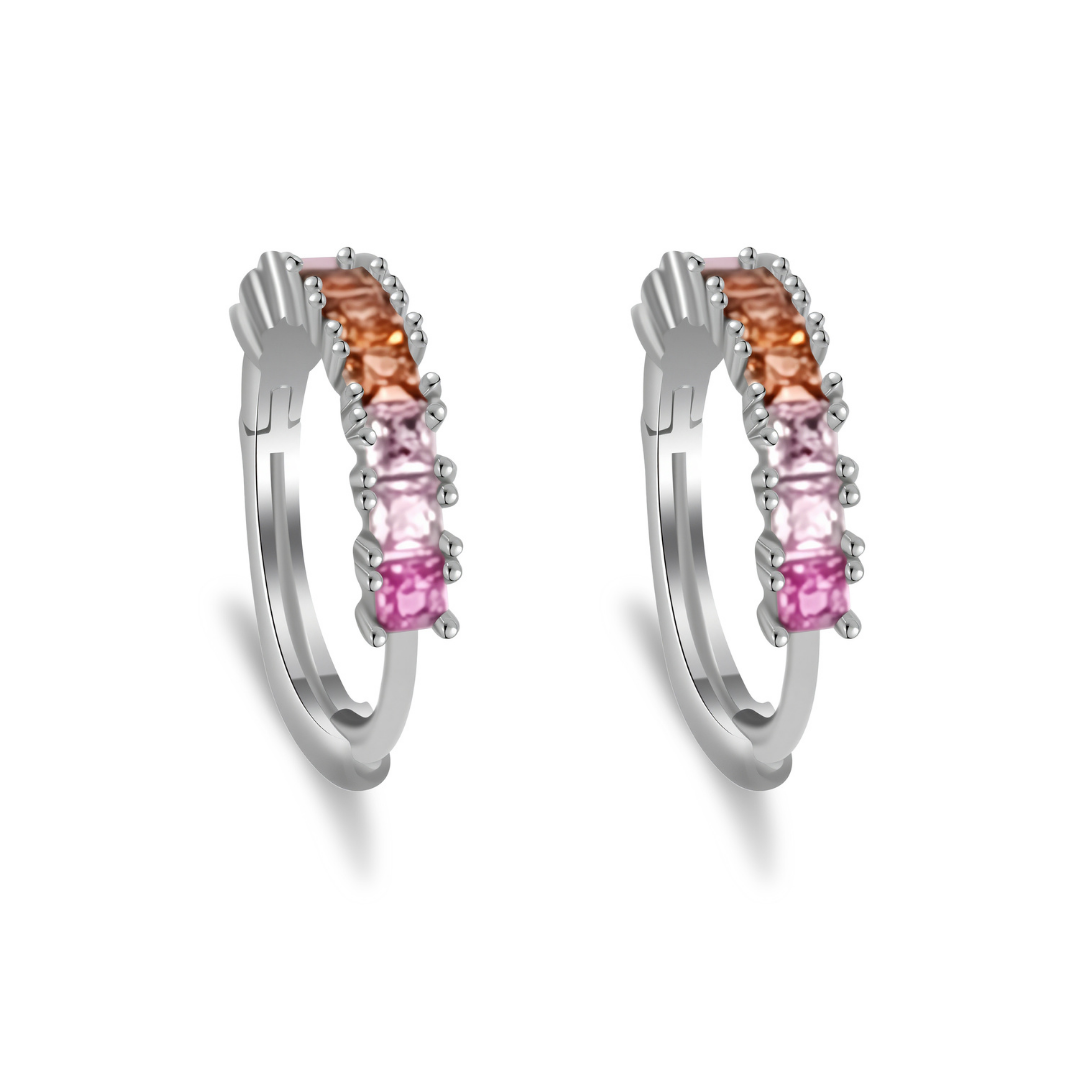 Ploutos Jewellery Aurora Gradient Zircon Huggie Hoops — rhodium-plated recycled 925 sterling silver earrings featuring pink, peach, and champagne gradient zircon stones. From the Abundance Collection, these elegant hoops capture the warmth of sunrise and symbolize renewal, grace, and inner confidence.