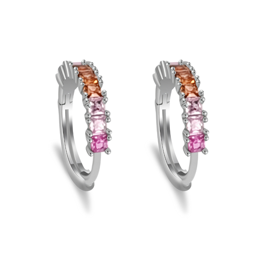 Ploutos Jewellery Aurora Gradient Zircon Huggie Hoops — rhodium-plated recycled 925 sterling silver earrings featuring pink, peach, and champagne gradient zircon stones. From the Abundance Collection, these elegant hoops capture the warmth of sunrise and symbolize renewal, grace, and inner confidence.