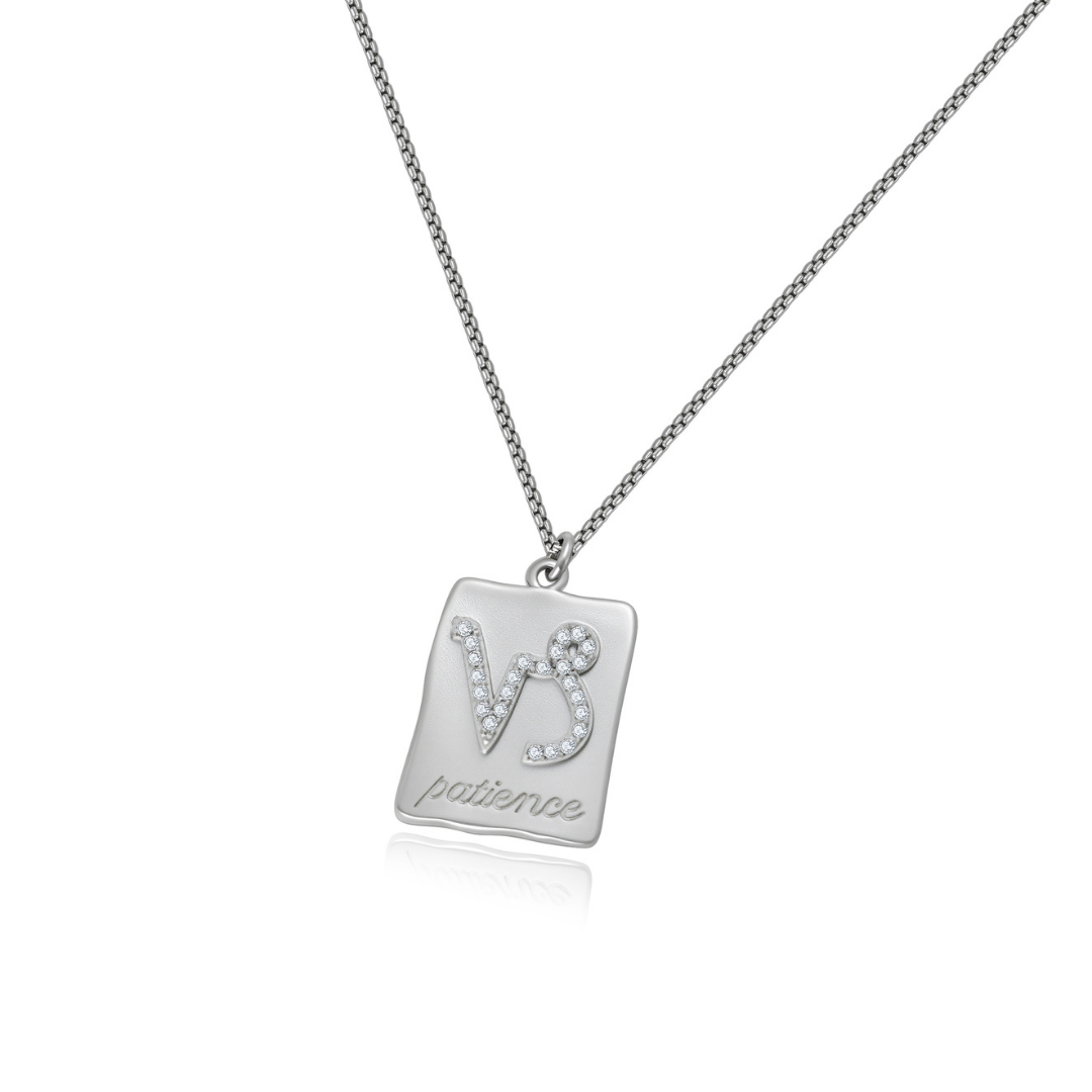 Ploutos Jewellery Capricorn Zodiac Necklace — handcrafted recycled 925 sterling silver pendant featuring the Capricorn symbol and the engraved word ‘patience’. Minimalist astrology necklace symbolising ambition, strength, and determination. Part of the Cosmic Energy Collection with adjustable chain for versatile styling.