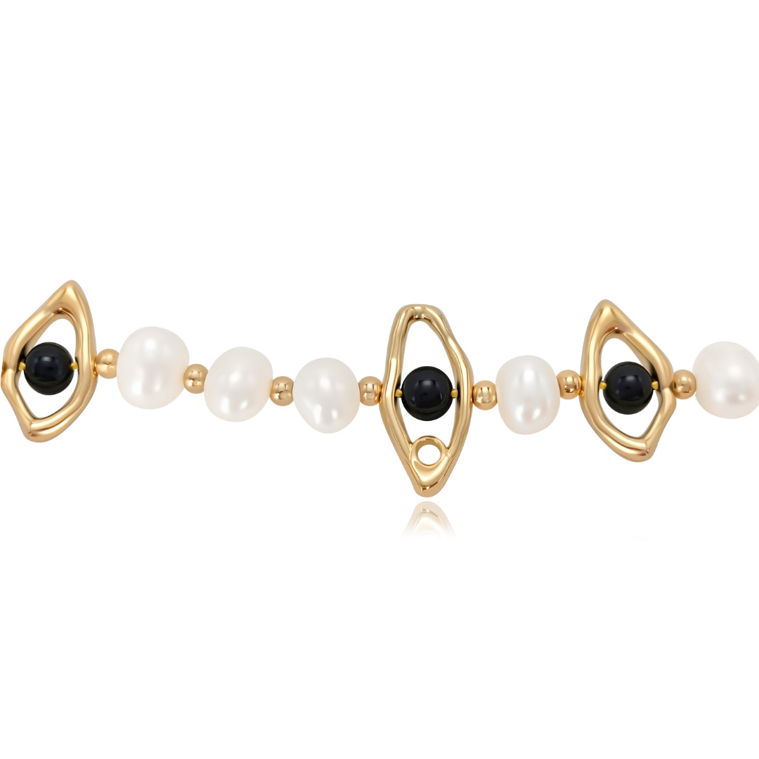 Close-up detail of the Ploutos Jewellery Celestial Eye Pearl Choker — featuring freshwater pearls, black onyx gemstones, and sculptural 18K vintage gold-plated recycled 925 sterling silver eye motifs. The design symbolizes intuition, protection, and harmony, reflecting the celestial balance of light and strength from the Cosmic Energy Collection