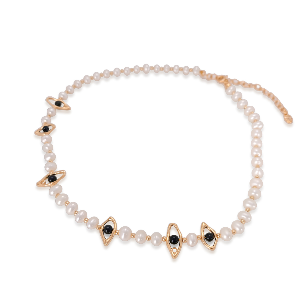 Ploutos Jewellery Celestial Eye Pearl Choker — handcrafted from freshwater pearls and black onyx gemstones set in 18K vintage gold-plated recycled 925 sterling silver. This elegant necklace from the Cosmic Energy Collection symbolizes intuition, protection, and balance through its modern eye motif and celestial-inspired design.