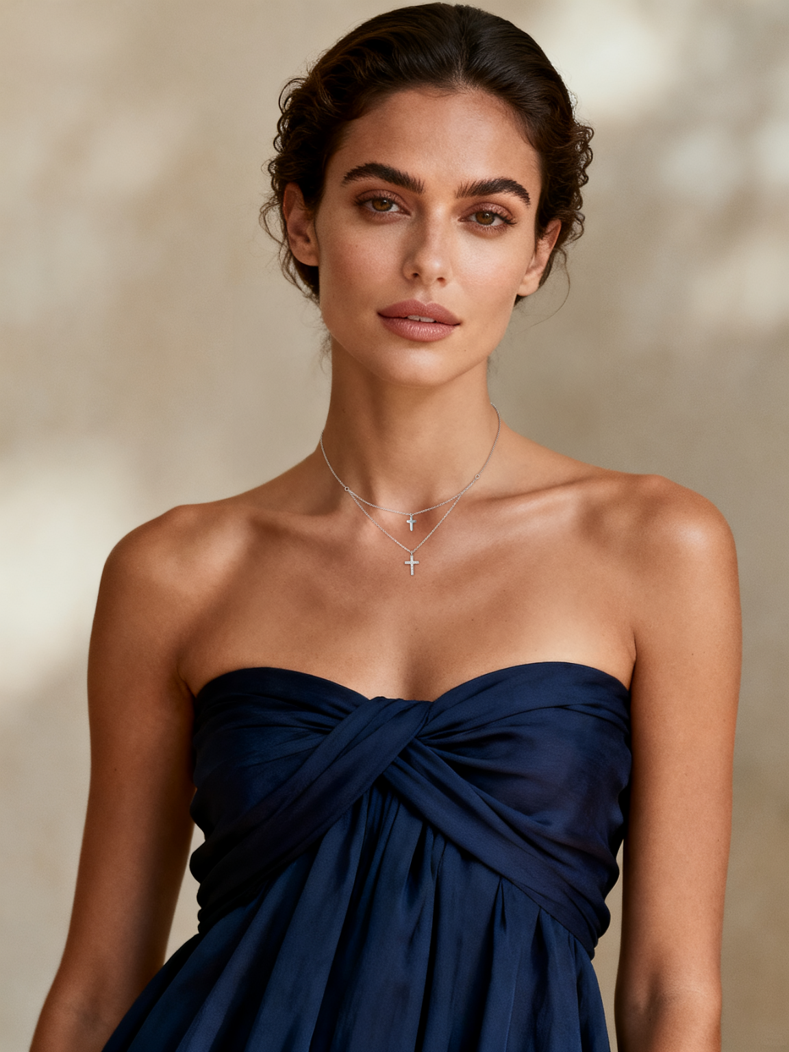 Model wearing Ploutos Jewellery Divine Grace Layered Cross Necklace — a delicate 925 sterling silver double-cross pendant representing serenity, faith, and inner protection. A radiant piece from the Cosmic Energy Collection, styled with timeless elegance and quiet confidence