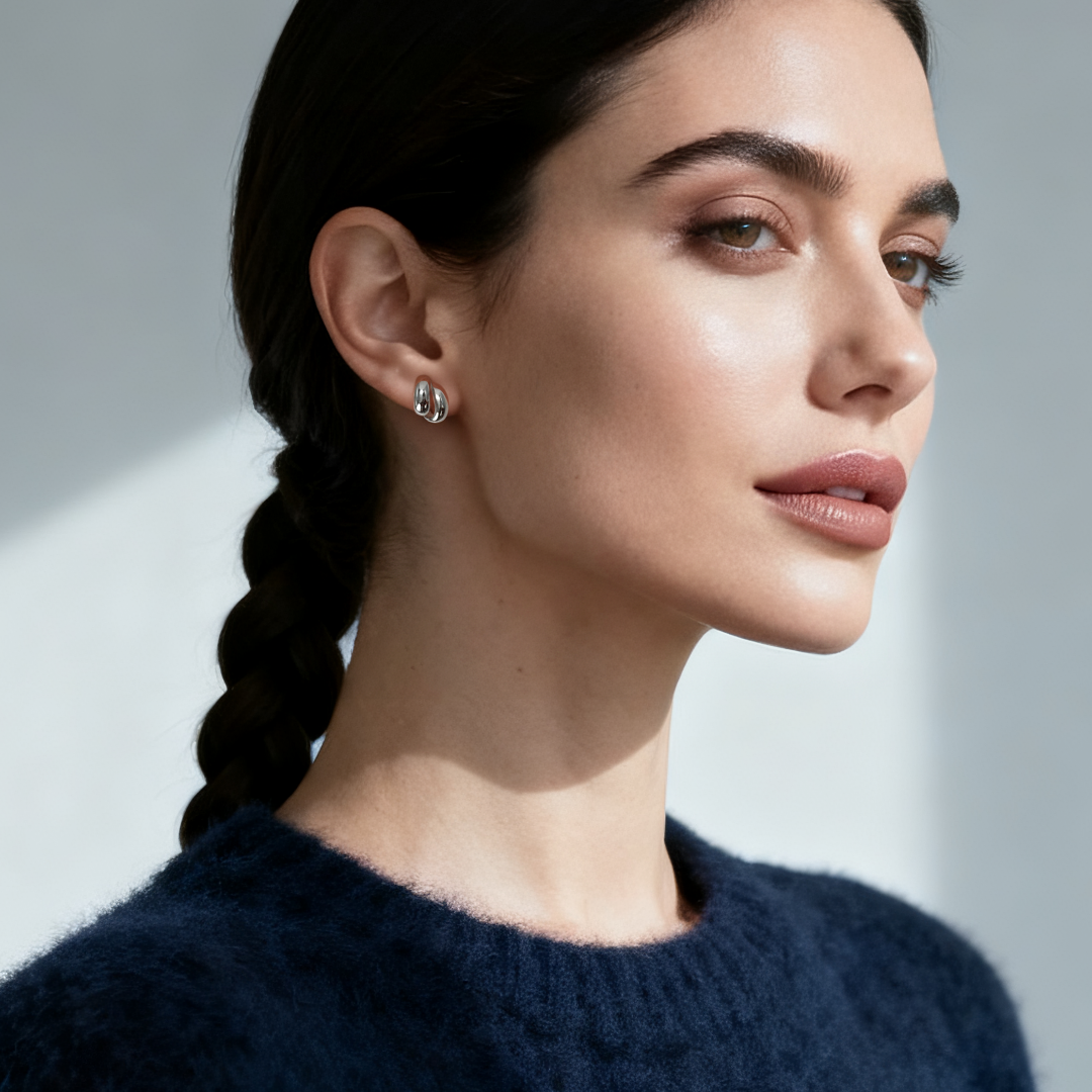 Model wearing Ploutos Jewellery Eclipse Duo Hoop Earrings in 925 sterling silver — elegant double-layer minimalist hoops from the Abundance Collection, radiating modern femininity and quiet luxury under natural light.