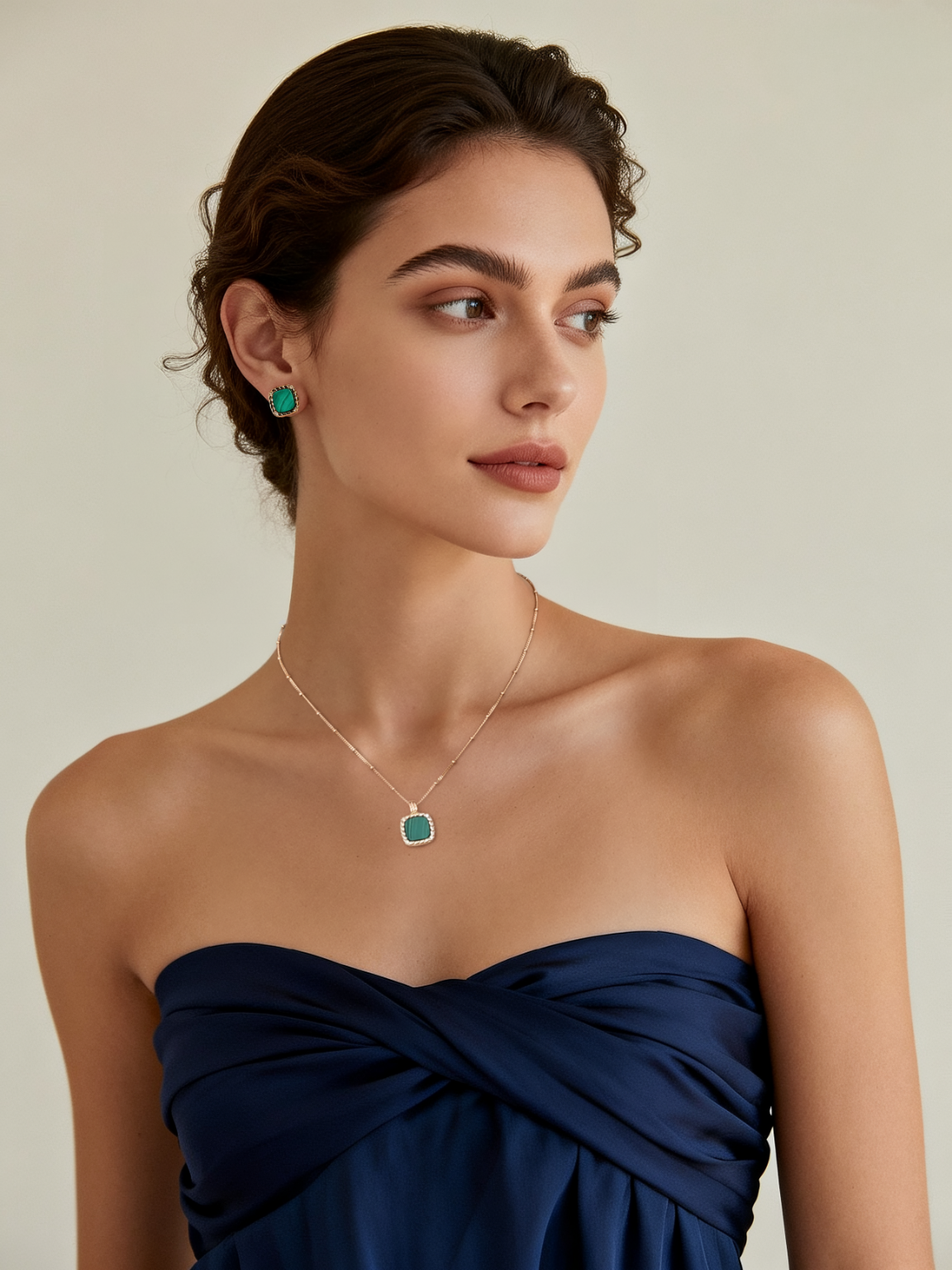 Model wearing Ploutos Jewellery Emerald Crest Malachite Necklace and Stud Earrings — elegant 18K gold-plated 925 sterling silver jewellery with deep green malachite gemstones. From the Cosmic Energy Collection, symbolizing balance, transformation, and timeless elegance.