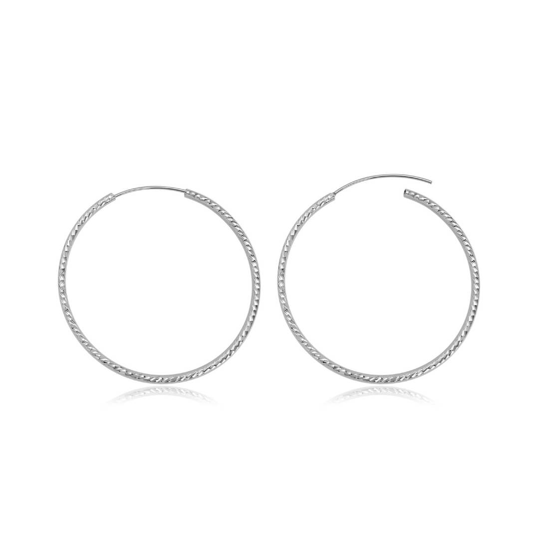 Ploutos Jewellery Eterna 50mm Twisted Silver Hoop Earrings — handcrafted large 925 sterling silver hoops with elegant twisted texture, lightweight and reflective design from the Abundance Collection symbolising modern grace and timeless allure.