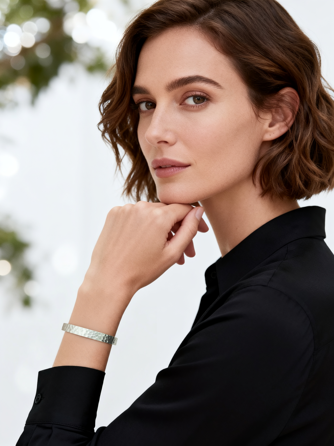 Model wearing the Ploutos Jewellery Ethereal Hammered Silver Bangle — handcrafted 999 fine silver open cuff bracelet with a subtle organic texture. A refined piece from the Wealth Collection, symbolising calm strength, timeless beauty, and quiet luxury.