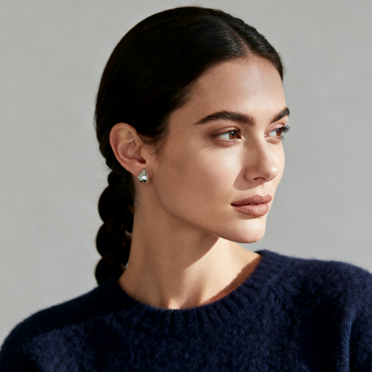 Model wearing Ploutos Jewellery Fluid Teardrop Stud Earrings — 925 sterling silver sculptural studs from the Abundance Collection, reflecting light with a smooth liquid-metal finish and minimalist elegance.