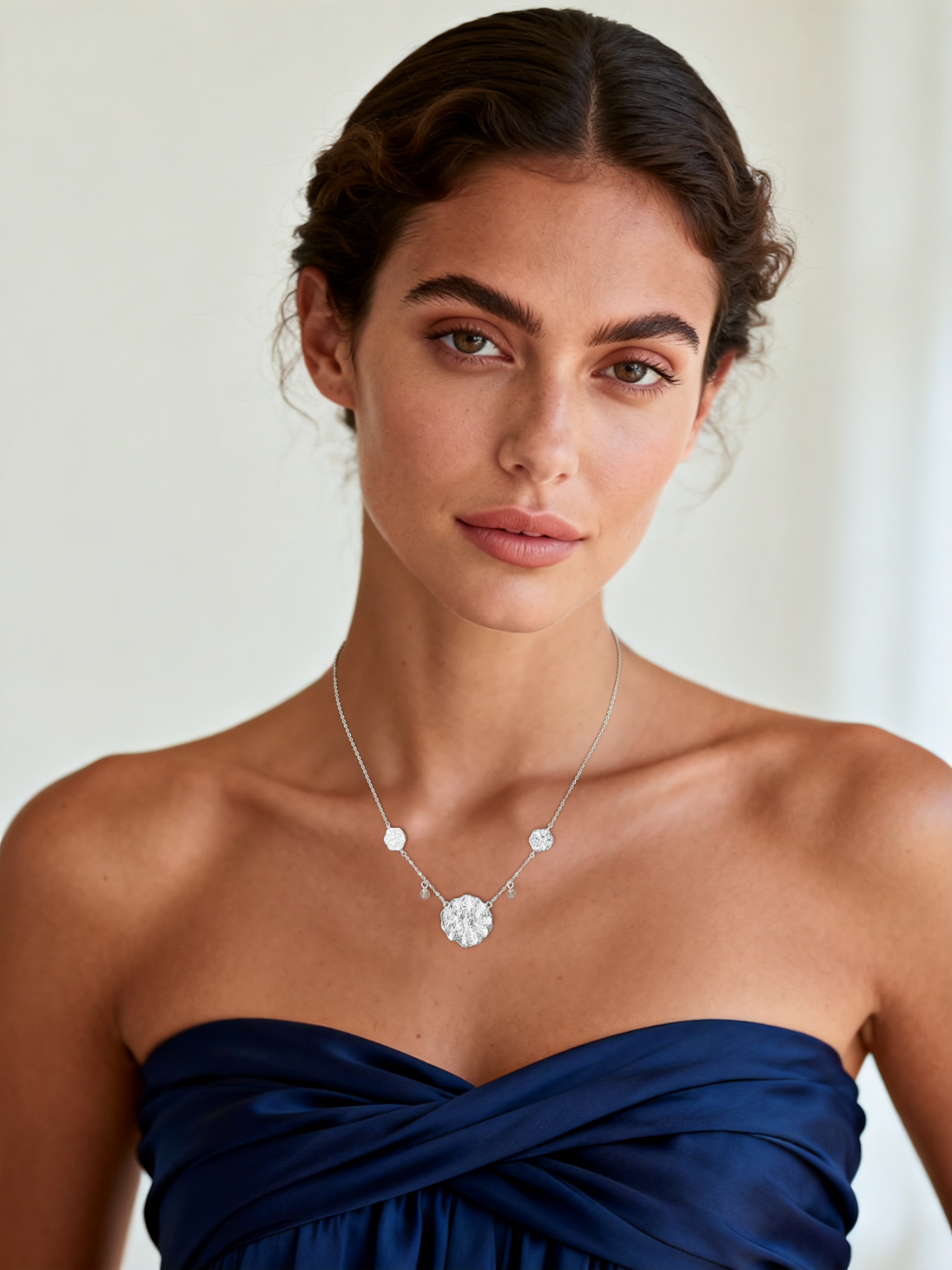 Model wearing Ploutos Jewellery Luna Bloom Silver Necklace — elegant 925 sterling silver floral medallion design with natural pearl accents. A luminous piece from the Cosmic Energy Collection symbolizing purity, serenity, and inner light.