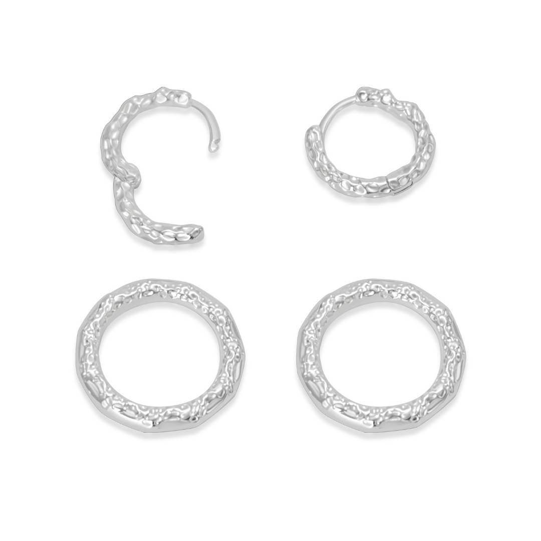 Model wearing Ploutos Jewellery Luna Duality Silver Earrings — handcrafted recycled 925 sterling silver textured hoops from the Abundance Collection. The detachable circular drops catch the light softly, pairing minimalist design with moonlit elegance. Styled with a navy knit for a refined, effortless look.