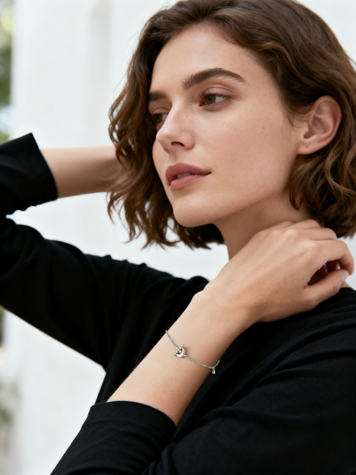 Model wearing Ploutos Jewellery Luna Étoile Bracelet — handcrafted 925 sterling silver bracelet featuring crescent moon, star, and cubic zirconia charms. A minimalist celestial design that embodies light, harmony, and refined femininity from the Abundance Collection.