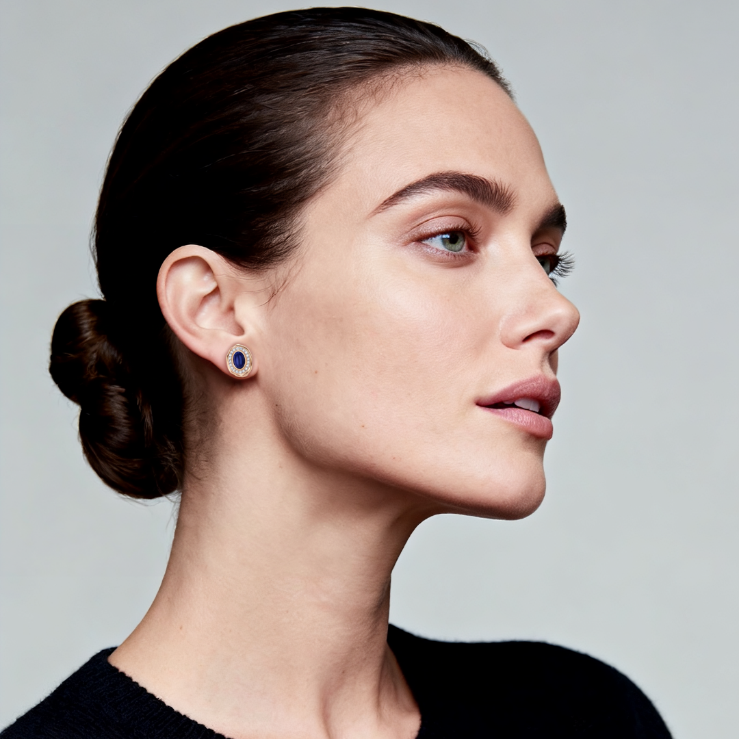 Model wearing Ploutos Jewellery Midnight Elegance Lapis Stud Earrings — 18K gold-plated 925 sterling silver with deep-blue lapis lazuli center and crystal halo. Captures celestial sophistication and timeless calm from the Cosmic Energy Collection.