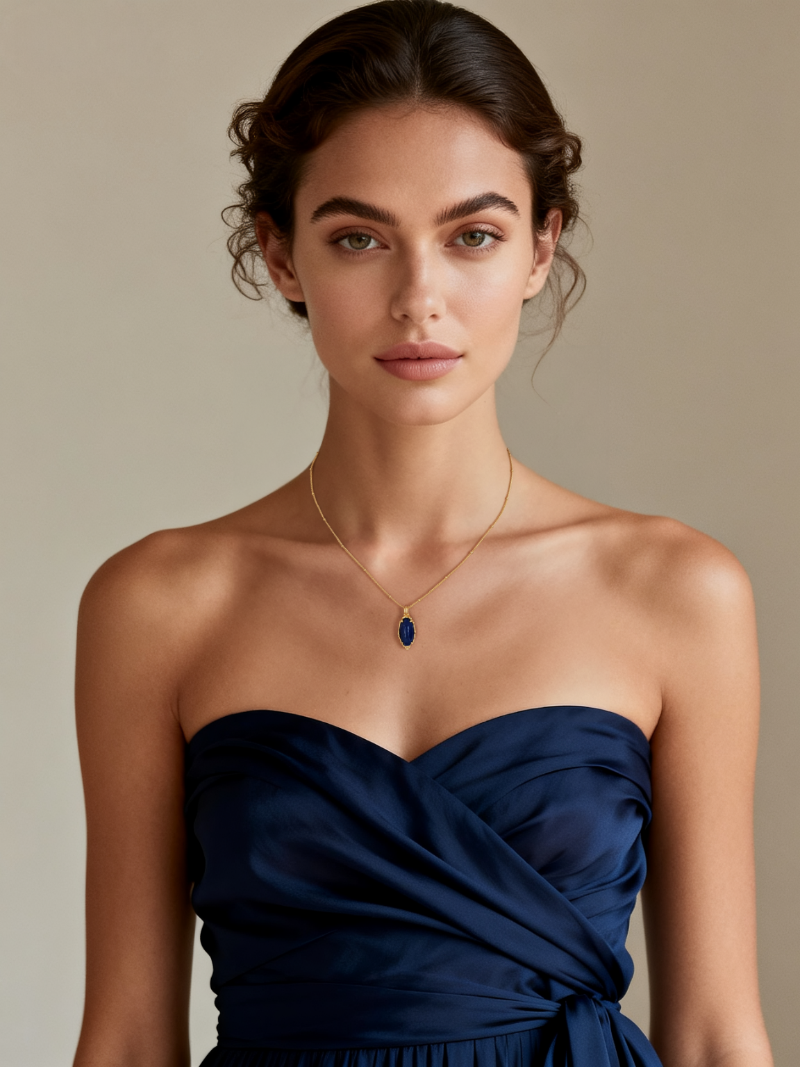 Model wearing Ploutos Jewellery Midnight Lapis Gold Necklace — elegant woman in navy satin dress showcasing 18K vintage gold-plated 925 sterling silver necklace with deep blue lapis lazuli pendant from the Cosmic Energy Collection. Sophisticated fine jewelry inspired by the night sky.