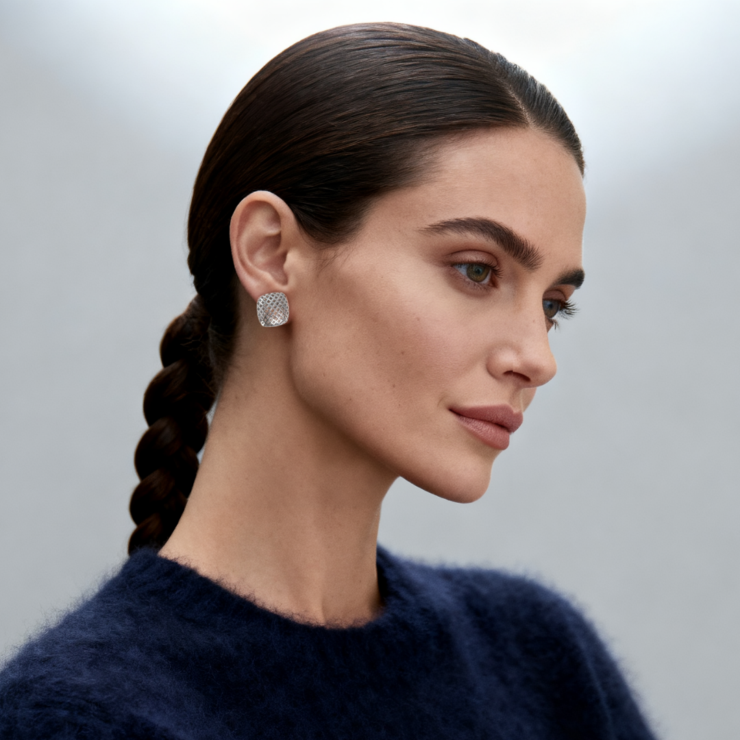 Model wearing Ploutos Jewellery Nova Mesh Silver Stud Earrings — rhodium-plated 925 sterling silver geometric studs with open lattice texture. From the Abundance Collection, showcasing modern elegance, minimalist design, and refined craftsmanship.