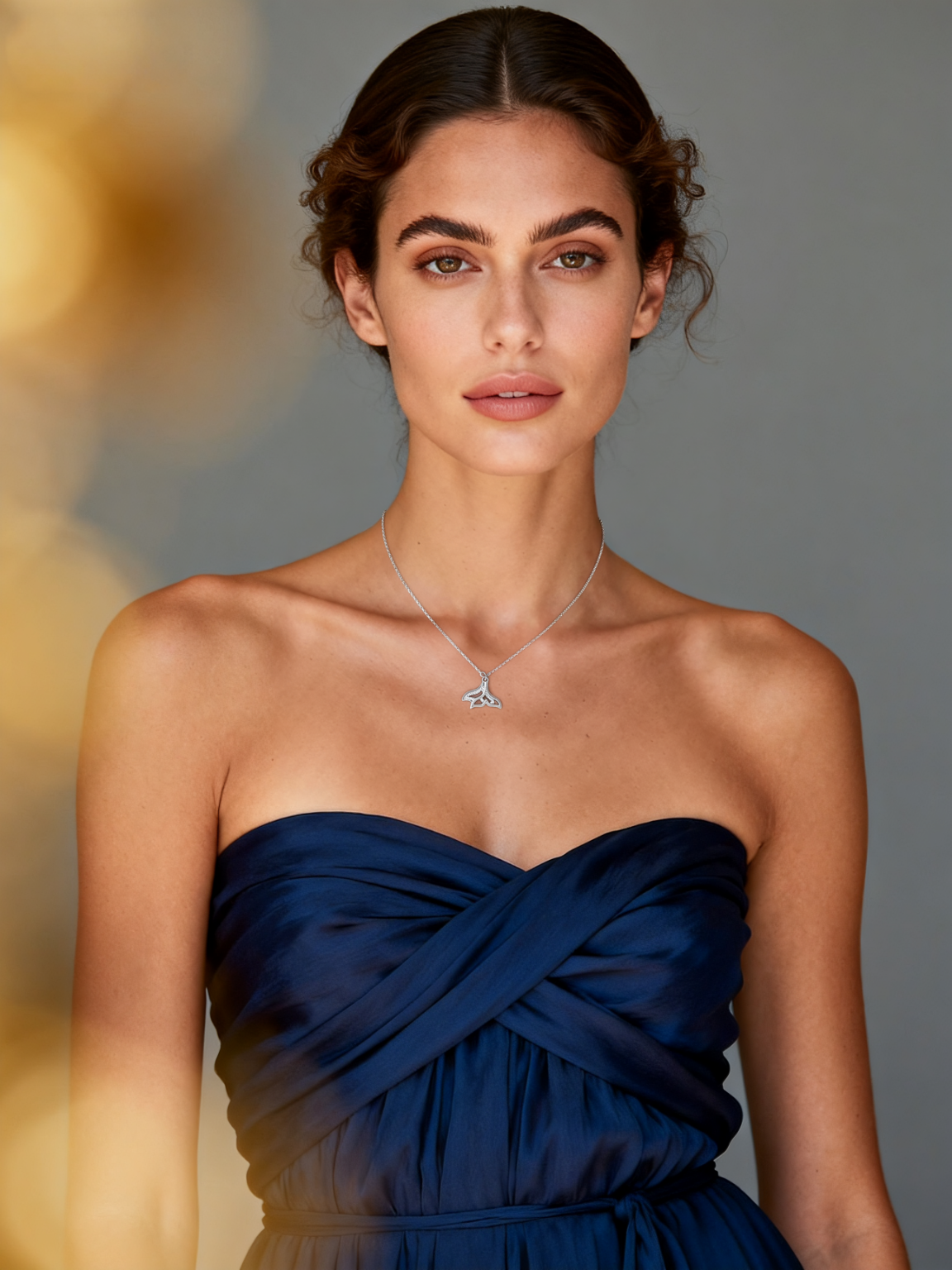 Model wearing Ploutos Jewellery Ocean Whisper Necklace — elegant whale tail pendant handcrafted in 925 sterling silver with shimmering zircon stones. From the Abundance Collection, this ocean-inspired necklace captures strength, grace, and a serene connection to nature’s rhythm.