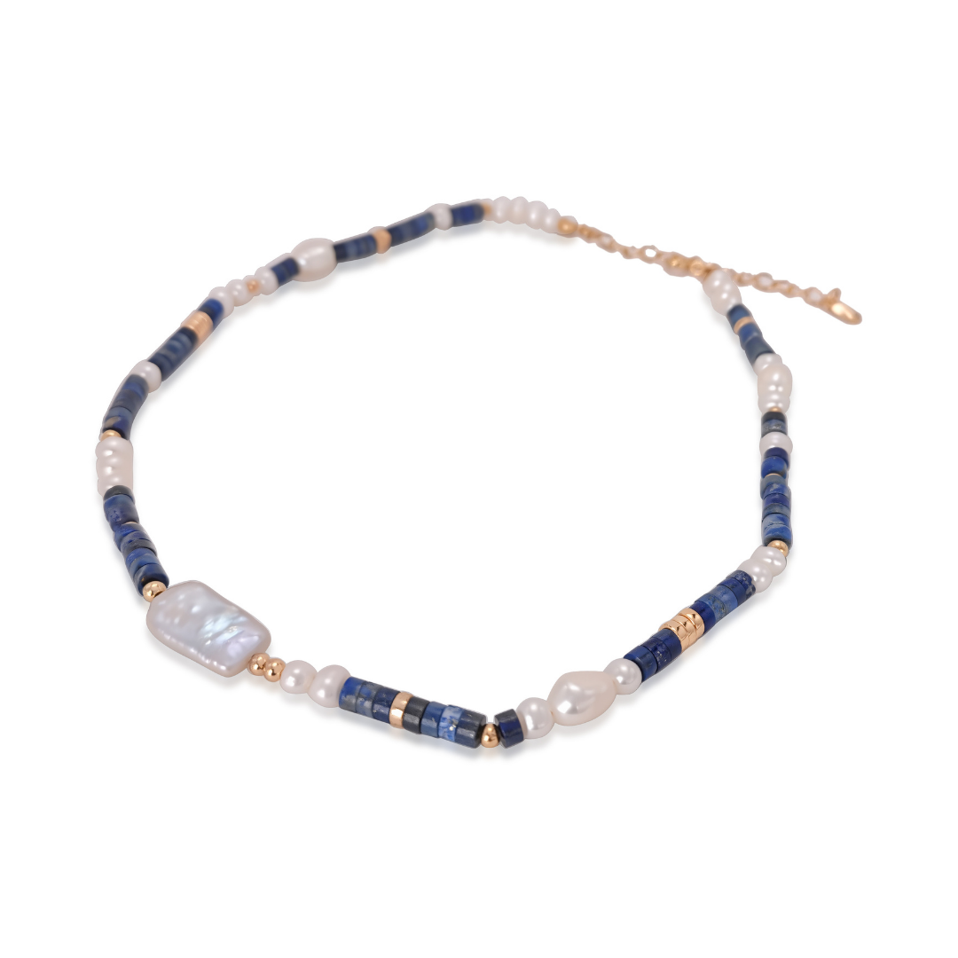Ploutos Jewellery Oceana Lapis Lazuli and Freshwater Pearl Bracelet — handcrafted with 18K vintage gold-plated recycled 925 sterling silver. This elegant bracelet from the Cosmic Energy Collection combines luminous pearls and deep blue lapis stones, embodying oceanic calm, feminine strength, and modern luxury.
