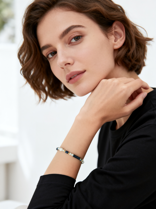 Model wearing Ploutos Jewellery Oceana Lapis Lazuli and Freshwater Pearl Bracelet — handcrafted from recycled 925 sterling silver with 18K vintage gold plating. This elegant bracelet from the Cosmic Energy Collection captures ocean-inspired serenity with the deep blue of lapis and the luminous glow of pearls, symbolizing balance and inner calm.