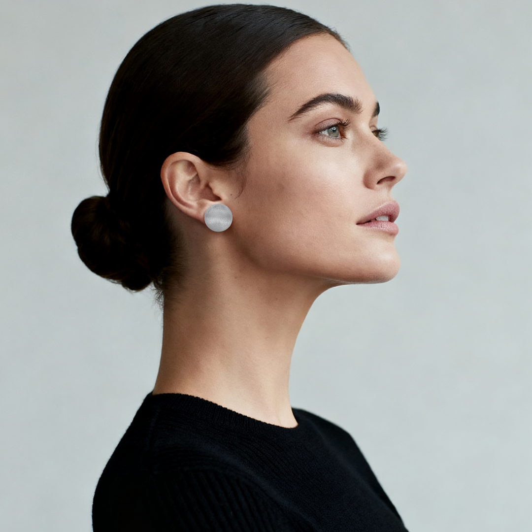 Model wearing Silver Halo Studs made from recycled 925 sterling silver — minimalist frosted satin earrings from the Abundance Collection by Ploutos Jewellery, reflecting quiet luxury and moonlit elegance.