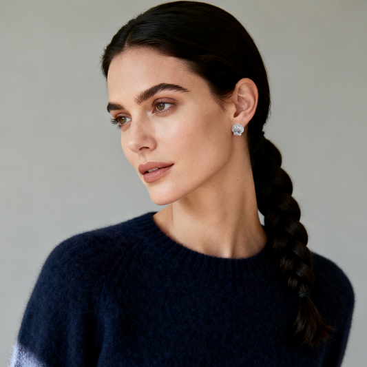 Model wearing Ploutos Jewellery Seaside Glow Silver Shell Earrings — recycled 925 sterling silver studs adorned with cubic zirconia, inspired by ocean shells and moonlight shimmer. Elegant minimalist style, part of the Abundance Collection, symbolizing serenity, grace, and effortless luxury.