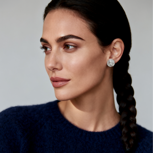 Model wearing Ploutos Jewellery Starlight Trail Silver Stud Earrings — handcrafted from 925 sterling silver with crater-textured dome and cubic zirconia shooting star accents. Elegant celestial-inspired earrings reflecting moonlit beauty and quiet luxury.