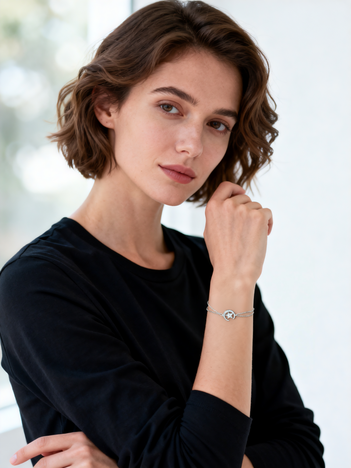 Model wearing Ploutos Jewellery Stellar Embrace Bracelet — a 925 sterling silver moon and star design featuring a mother-of-pearl inlay. Styled with a minimalist black top, the bracelet radiates celestial elegance and quiet confidence, part of the Abundance Collection.