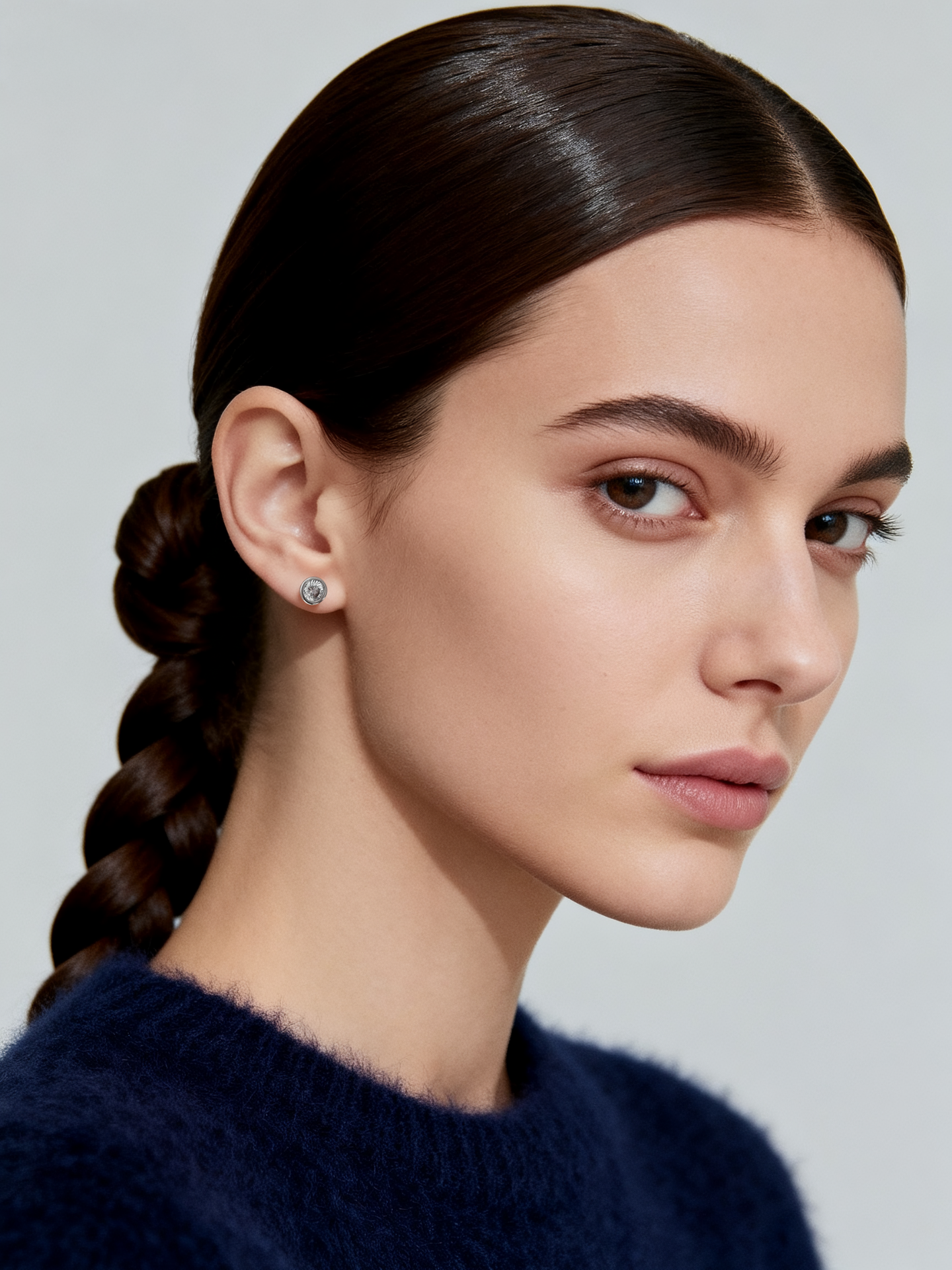 Model wearing Ploutos Jewellery Timeless Sparkle Zircon Stud Earrings, 5mm size — handcrafted in recycled 925 sterling silver with precision-cut cubic zirconia. Dainty yet radiant, these minimalist earrings from the Abundance Collection bring effortless sophistication to any look.