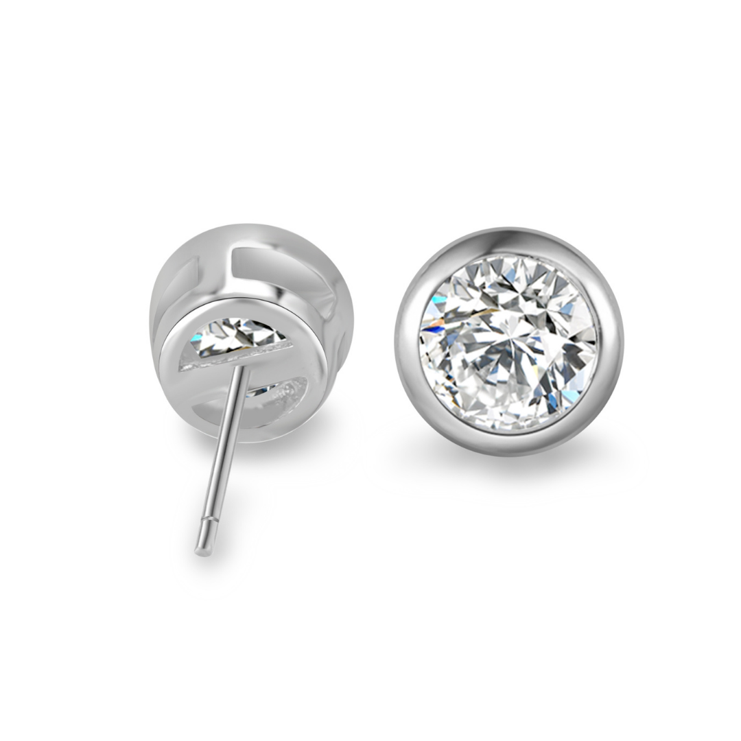 Close-up of Ploutos Jewellery Timeless Sparkle Zircon Stud Earrings in 925 sterling silver — bezel-set brilliant-cut cubic zirconia studs with open-back design for maximum light reflection. Elegant and durable, perfect for everyday luxury and timeless minimal style.