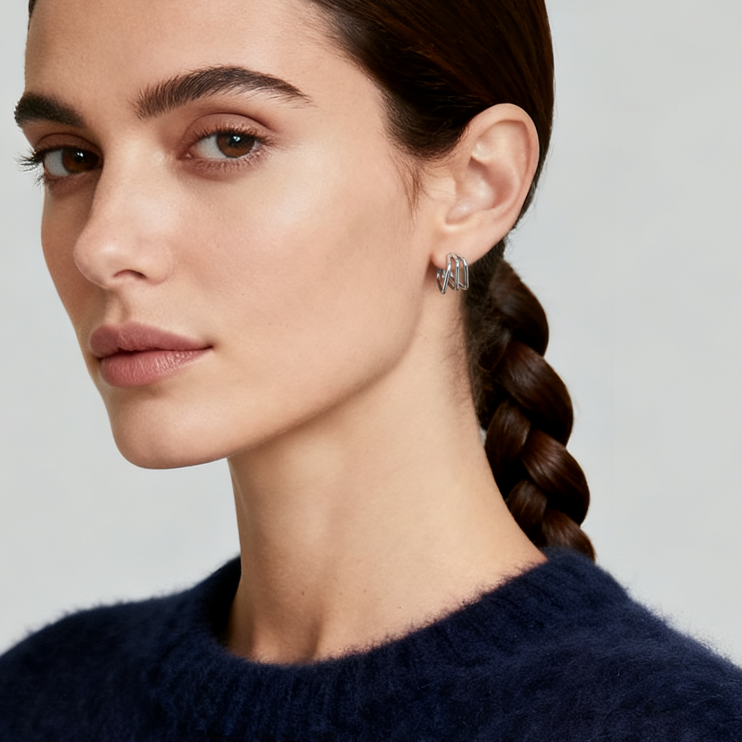 Model wearing Ploutos Jewellery Trinity Square Hoop Earrings — 925 sterling silver triple-layer geometric hoops from the Abundance Collection, reflecting modern minimalist style and quiet luxury.