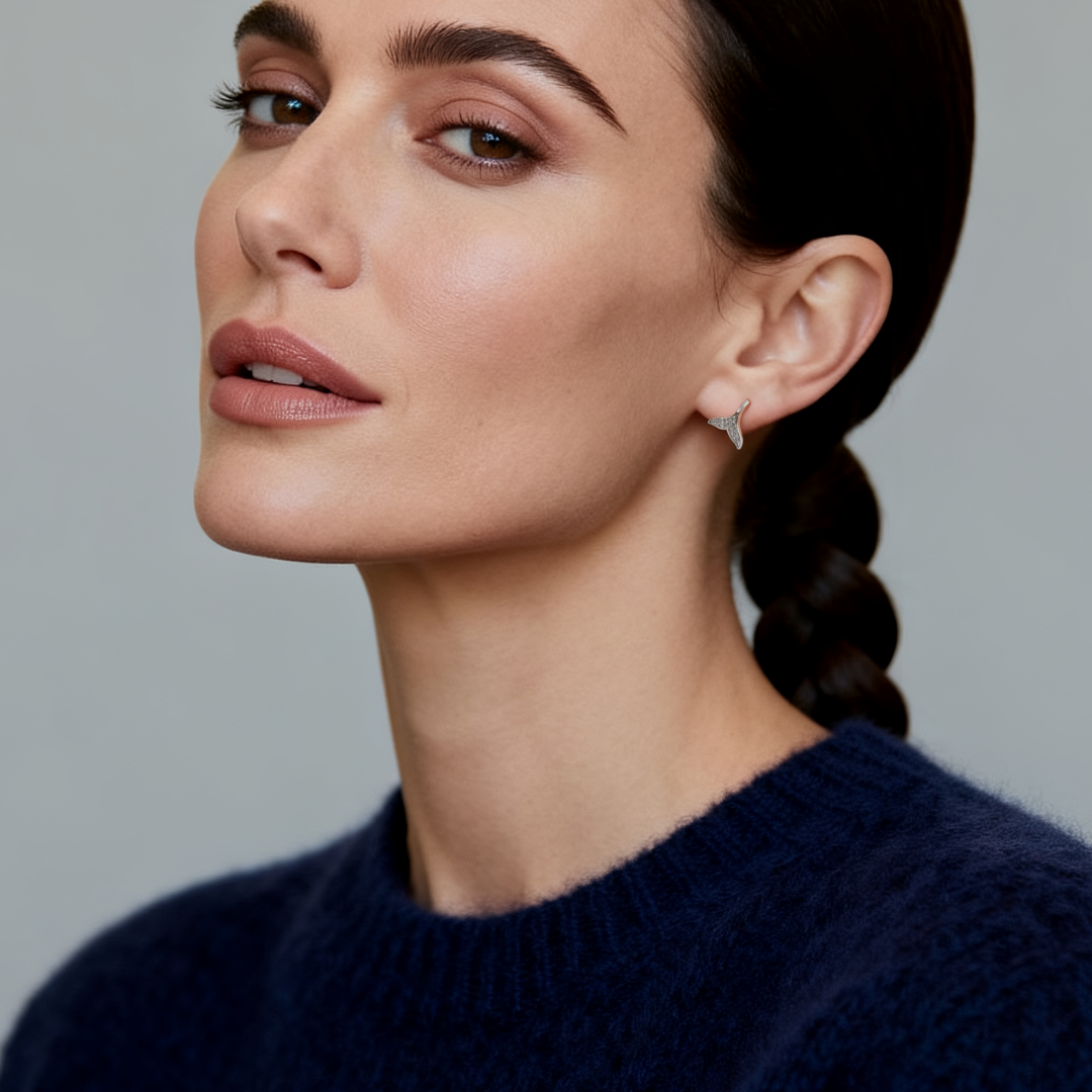 Model wearing Ploutos Jewellery Whale Tail Harmony Stud Earrings — 925 sterling silver ocean-inspired studs with sparkling stones from the Abundance Collection, symbolising freedom, grace, and emotional balance.